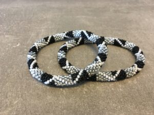 Roll-on perle armbåndene er håndlavet i Nepal. De er lavet med forskellige glasperler og i forskellige mønster. De er hæklet med en bomuldssnor. Syntes man at de lidt stramme, kan man vride forsigtigt i dem så de bliver større. syntes man derimod at de er blive lidt for løse, kan man ligge dem i vand. dette gør at bomildssnoren trækker sig sammen og de bliver mindre igen.
