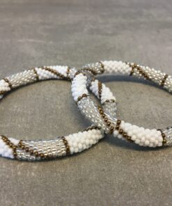 Roll-on perle armbåndene er håndlavet i Nepal. De er lavet med forskellige glasperler og i forskellige mønster. De er hæklet med en bomuldssnor. Syntes man at de lidt stramme, kan man vride forsigtigt i dem så de bliver større. syntes man derimod at de er blive lidt for løse, kan man ligge dem i vand. dette gør at bomildssnoren trækker sig sammen og de bliver mindre igen.