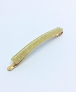 Hårnål fra Winga i en elegant guld farve med glitter