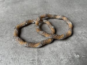 Nepal perle armbånd Nepal armbånd er en inspirerende og fascinerende smykkegenre, der vækker interessen hos smykkeentusiaster over hele verden. Disse håndlavede armbånd er kunstværker, der udstråler autenticitet, skønhed og dyb symbolik. Lad os dykke ned i den betagende verden af Nepal armbånd og udforske, hvad der gør dem så unikke og eftertragtede. Hvert Nepal armbånd er unikt, og det er netop denne individualitet, der appellerer til mange. Armbåndene er ofte skabt af dygtige nepalesiske håndværkere, der gennem generationer har forfinet deres teknikker til at skabe smykker af høj kvalitet. Disse håndværkere bruger traditionelle metoder, som har været en del af Nepals kultur og historie i århundreder. Processen er omhyggelig og kræver en stor grad af præcision og tålmodighed, hvilket gør hvert armbånd til en kærlighedsfyldt skabelse. Nepal armbånd er kendt for deres farverige og levende design. De er ofte dekoreret med perler, ædelstene, træ, metal eller andre naturlige materialer, hvilket giver dem et unikt udseende. Hvert enkelt element, der anvendes i armbåndene, er udvalgt omhyggeligt for at skabe en harmonisk kombination af farver og teksturer. Disse elementer er ofte inspireret af Nepals rige natur og kultur, hvilket giver armbåndene en autentisk følelse og en stærk forbindelse til landet. Symbolik spiller også en vigtig rolle i Nepal armbåndenes popularitet. Mange af armbåndene har indgraverede mønstre eller symboler, der repræsenterer vigtige aspekter af Nepals traditioner og spiritualitet. Disse symboler kan have betydning for held, lykke, kærlighed, beskyttelse eller en dybere forbindelse til naturen. At bære et Nepal armbånd kan derfor have en dybere betydning for bæreren og kan fungere som en påmindelse om deres forbindelse til Nepals rige arv. Nepal armbånd er ikke kun smukke smykker, men de har også en stærk social og kulturel betydning. Mange af disse smykker er håndlavede af kvinder, der er en del af samfundet i landområderne i Nepal. Produktionen af armbåndene giver disse kvinder mulighed for at skabe en bæredygtig indkomst, forbedre deres levevilkår og styrke deres selvstændighed. Når du køber et Nepal armbånd, bidrager du derfor til at støtte en positiv social indvirkning og bevare traditionelle håndværksmæssige metoder. Udover deres kulturelle og sociale betydning er Nepal armbånd også en favorit blandt modebevidste enkeltpersoner, der ønsker at tilføje en unik og autentisk touch til deres stil. Disse armbånd kan styles på utallige måder, uanset om du ønsker at skabe et bohemeinspireret look, en farverig festlig stil eller en subtil og elegant kombination. Der er et Nepal armbånd til enhver lejlighed og enhver personlig præference. I det store udvalg af smykker, der findes i dagens marked, skiller Nepal armbånd sig ud som en særlig perle. Deres håndlavede karakter, farverige design, dybe symbolik og sociale indvirkning gør dem til mere end bare smykker - de er en form for kunst og kultur, der fortæller historien om Nepal og dets folk. Ved at bære et Nepal armbånd, bærer du også med dig en del af dette rige og inspirerende land. Så uanset om du leder efter en meningsfuld gave eller ønsker at berige din egen smykkesamling, vil et Nepal armbånd være et mindeværdigt og værdsat valg.