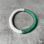 Nepal perle armbånd Nepal armbånd er en inspirerende og fascinerende smykkegenre, der vækker interessen hos smykkeentusiaster over hele verden. Disse håndlavede armbånd er kunstværker, der udstråler autenticitet, skønhed og dyb symbolik. Lad os dykke ned i den betagende verden af Nepal armbånd og udforske, hvad der gør dem så unikke og eftertragtede. Hvert Nepal armbånd er unikt, og det er netop denne individualitet, der appellerer til mange. Armbåndene er ofte skabt af dygtige nepalesiske håndværkere, der gennem generationer har forfinet deres teknikker til at skabe smykker af høj kvalitet. Disse håndværkere bruger traditionelle metoder, som har været en del af Nepals kultur og historie i århundreder. Processen er omhyggelig og kræver en stor grad af præcision og tålmodighed, hvilket gør hvert armbånd til en kærlighedsfyldt skabelse. Nepal armbånd er kendt for deres farverige og levende design. De er ofte dekoreret med perler, ædelstene, træ, metal eller andre naturlige materialer, hvilket giver dem et unikt udseende. Hvert enkelt element, der anvendes i armbåndene, er udvalgt omhyggeligt for at skabe en harmonisk kombination af farver og teksturer. Disse elementer er ofte inspireret af Nepals rige natur og kultur, hvilket giver armbåndene en autentisk følelse og en stærk forbindelse til landet. Symbolik spiller også en vigtig rolle i Nepal armbåndenes popularitet. Mange af armbåndene har indgraverede mønstre eller symboler, der repræsenterer vigtige aspekter af Nepals traditioner og spiritualitet. Disse symboler kan have betydning for held, lykke, kærlighed, beskyttelse eller en dybere forbindelse til naturen. At bære et Nepal armbånd kan derfor have en dybere betydning for bæreren og kan fungere som en påmindelse om deres forbindelse til Nepals rige arv. Nepal armbånd er ikke kun smukke smykker, men de har også en stærk social og kulturel betydning. Mange af disse smykker er håndlavede af kvinder, der er en del af samfundet i landområderne i Nepal. Produktionen af armbåndene giver disse kvinder mulighed for at skabe en bæredygtig indkomst, forbedre deres levevilkår og styrke deres selvstændighed. Når du køber et Nepal armbånd, bidrager du derfor til at støtte en positiv social indvirkning og bevare traditionelle håndværksmæssige metoder. Udover deres kulturelle og sociale betydning er Nepal armbånd også en favorit blandt modebevidste enkeltpersoner, der ønsker at tilføje en unik og autentisk touch til deres stil. Disse armbånd kan styles på utallige måder, uanset om du ønsker at skabe et bohemeinspireret look, en farverig festlig stil eller en subtil og elegant kombination. Der er et Nepal armbånd til enhver lejlighed og enhver personlig præference. I det store udvalg af smykker, der findes i dagens marked, skiller Nepal armbånd sig ud som en særlig perle. Deres håndlavede karakter, farverige design, dybe symbolik og sociale indvirkning gør dem til mere end bare smykker - de er en form for kunst og kultur, der fortæller historien om Nepal og dets folk. Ved at bære et Nepal armbånd, bærer du også med dig en del af dette rige og inspirerende land. Så uanset om du leder efter en meningsfuld gave eller ønsker at berige din egen smykkesamling, vil et Nepal armbånd være et mindeværdigt og værdsat valg.