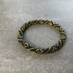 Unikke håndlavet nepal armbånd af glasperler- Som er knyttet perle for perle – Af Nepalesiske Kvinder.  Kvindegrupper i Nepal, Kathmandu Valley, udstyres med glasperler og bomuldsgarn, så de i deres fritid kan håndknytte de smukke perlearmbånd. Hvert armbånd er et unikt resultat af kvindernes håndarbejde og varierer i farvekombinationer og mønstre. De er hæklet med en bomuldssnor. Syntes man at de lidt stramme, kan man vride forsigtigt i dem så de bliver større. syntes man derimod at de er blive lidt for løse, kan man ligge dem i vand. dette gør at bomuldssnoren trækker sig sammen og de bliver mindre igen. Unikke håndlavet nepal armbånd, som er knyttet perle for perle, af nepalesiske kvinder. Vi har mere end 200 forskellige, at vælge i mellem. Så du kan finde de helt rigtige roll on nepal perle armbånd.